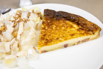 slice of quiche and endive salad