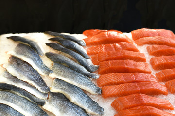 Sliced sea bass fillet and salmon fillet for cooking