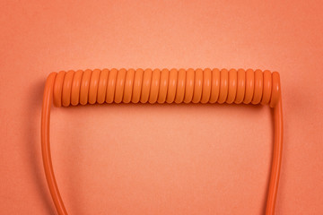 Orange spiral cable on orange background