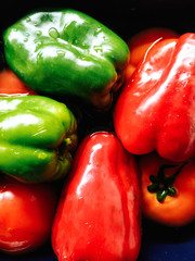 Tomatoes, green and red bell peppers in the kitchen.
