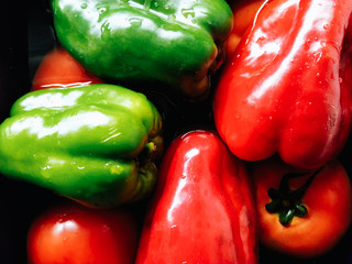 Tomatoes, green and red bell peppers in the kitchen.