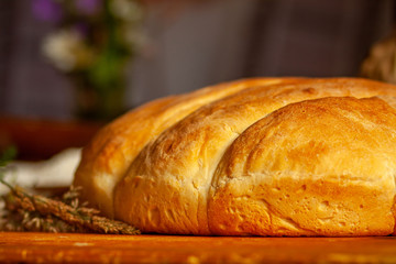 fresh wheat homemade bread on the wooden table