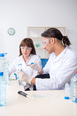 Two chemists working in the lab