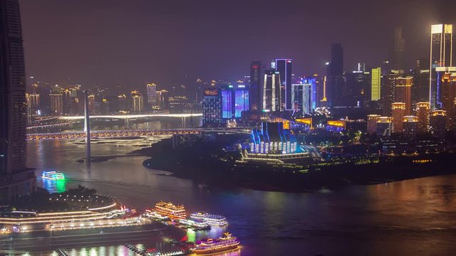 Chongqing night city river cityscape with bridges aerial China timelapse pan up