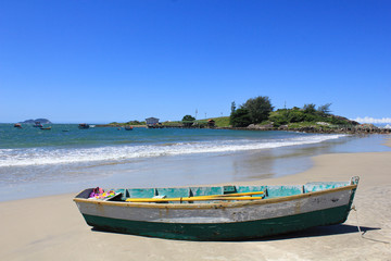 Naklejka na ściany i meble Solitary wooden fishing boat at sea beach with beautiful sky