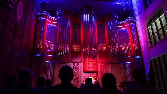 A view of philharmonia philharmonic concert hall isle with pipe organ playing classical music