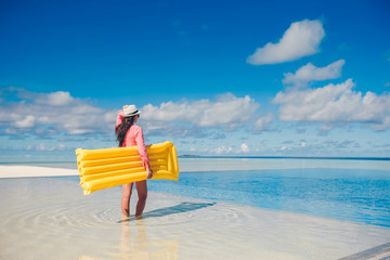 Young happy woman relaxing in a swimming pool