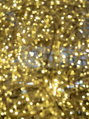 Christmas and new year lights. Blurred lights of Golden color. Can be used as background and texture