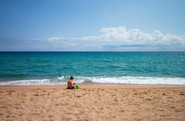 Fototapeta na wymiar Caucasian boy playing on the beach