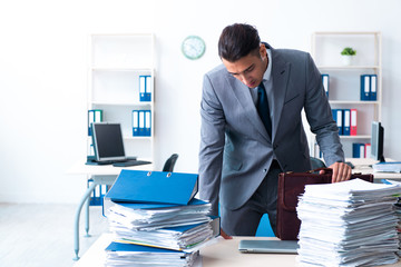 Businessman with heavy paperwork workload