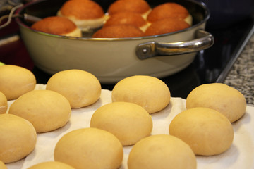 Risen yeast dough balls on fabric and baking in pan for making original homemade Austrian Carnival...