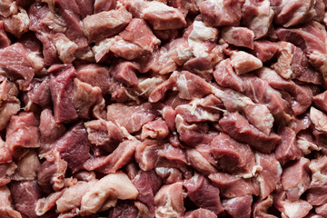 Heap of raw diced beef meat isolated, top view