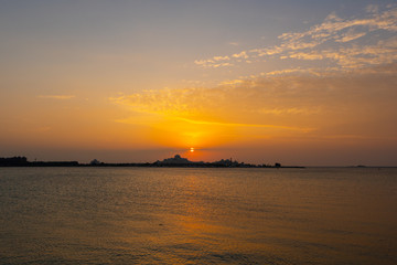 Fototapeta premium Beautiful sunset with lights reflections on the water 