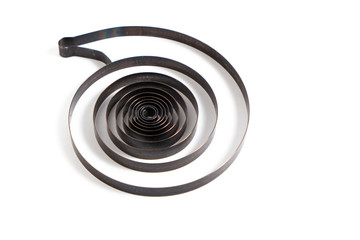 Spring from a broken mechanical watch.On white background.