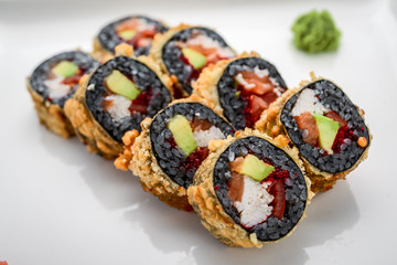 Sushi Roll made of Fresh Salmon, Avocado and Cream Cheese with black rice