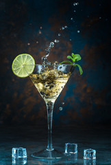Mojito cocktail in martini glass on black background