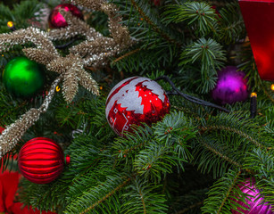 Christmas and New Year composition. Christmas tree branch decorated with Xmas lights,  balls, cones, snowflakes, baubles. Holiday background.