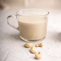 Glass cup with organic milk. Nut milk without lactose, gmo, antibiotics and casein. Diet drink. ..