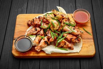 chicken wings and legs on a wooden table
