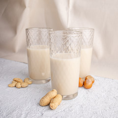 Three glasses with different types of organic milk. Nut milk without lactose, gmo, antibiotics and casein. Diet drink.