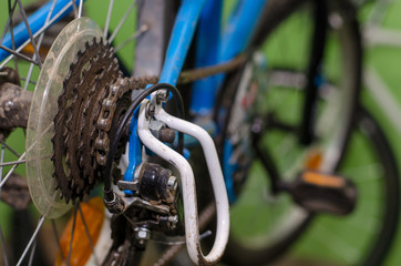 children's bike repair. View of the rear wheel and cassette close-up. Rusty old parts are replaced by new ones. High quality workshop. Rear derailleur broke.