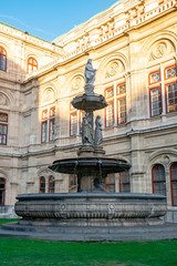 Fototapeta na wymiar A fountain with Statues in front of the Opera in Vienna, Austria