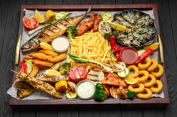 fried fish, mussels, and shrimp with potatoes
