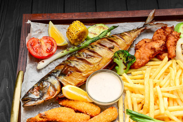 fried fish, mussels, and shrimp with potatoes
