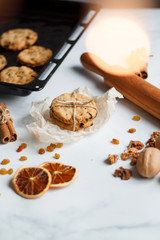 Christmas composition. cookies tied, rolling pin, cinnamon, cookies and dried orange, nuts, raisins. 