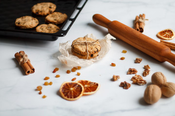 Christmas composition. cookies tied, rolling pin, cinnamon, cookies and dried orange, nuts, raisins. 
