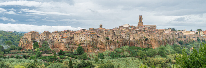 Fototapeta na wymiar View of the medieval village Pitigliano founded in Etruscan time on the tuff hill, Tuscany, Italy. Wide banner