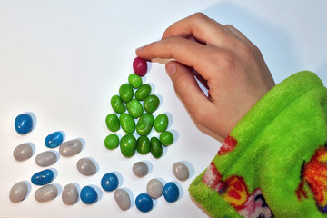 Christmas tree of colorful candies, made by a child