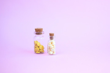 homeopathic globules and glass bottle on pink background. Alternative Homeopathy medicine herbs, healtcare and pills concept. Flatlay. Top view. copyspace for text.