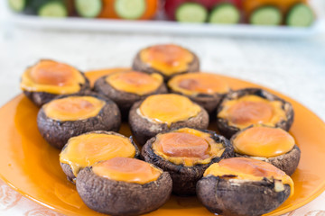 Mushrooms with cheddar cheese on a plate
