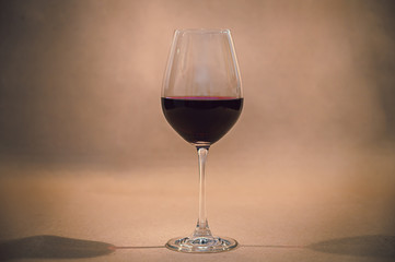 Glass of red wine on rustic background