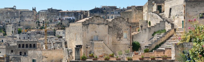 Fototapeta na wymiar Matera is a city located on a rocky outcrop in Basilicata, in Southern Italy. It includes the area of the Sassi, a complex of Cave Houses excavated in the mountain.