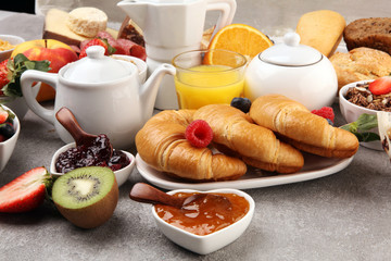 Breakfast served with coffee, orange juice, croissants, cereals and fruits. Balanced diet. Continental breakfast with granola and fruits