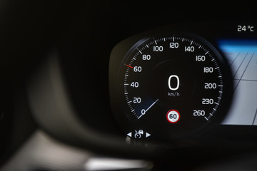 Speedometer in black background and traffic sign recognition system.