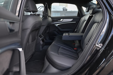 Fototapeta na wymiar Rear black leather seats of the new car.