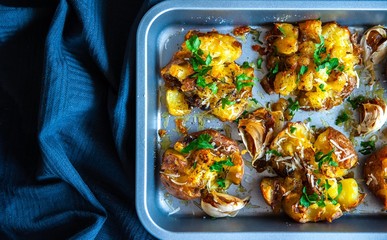 Top view of the roasted and baked potatoes in oven tray