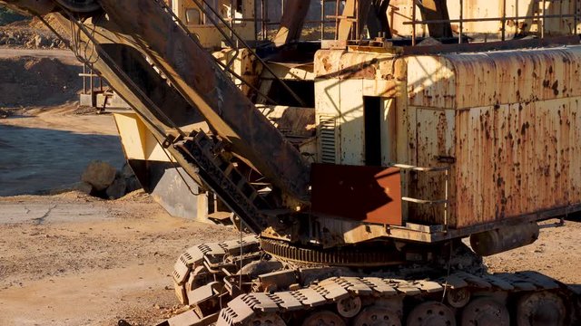 Excavator machine abandoned in old mine.
