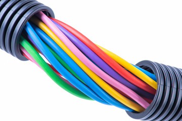 Colorful electrical cables in protective corrugated pipe isolated on white background
