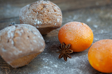 delicious fresh muffins with flour on a wooden table