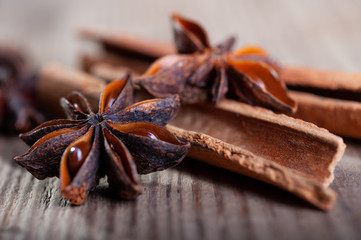 cinnamon and star anise sticks lie on an old wooden background close-up