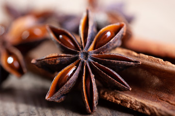 cinnamon and star anise sticks lie on an old wooden background close-up