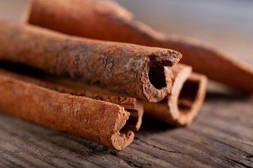 cinnamon sticks lie on an old wooden background close-up