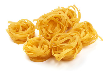 Raw tagliatelle pasta, isolated on white background