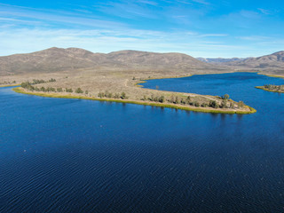 Aerial view of Otay Lake Reservoir with blue sky and mountain on the background, Chula Vista, California. USA