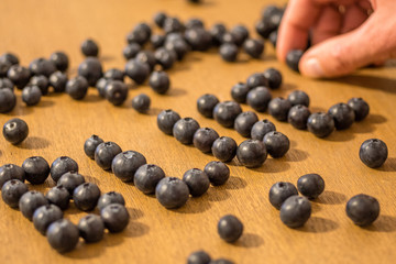 Man writting blue with blueberries