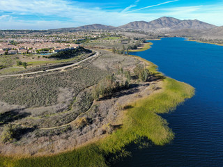 Aerial view of Otay Lake Reservoir with blue sky and mountain on the background, Chula Vista, California. USA